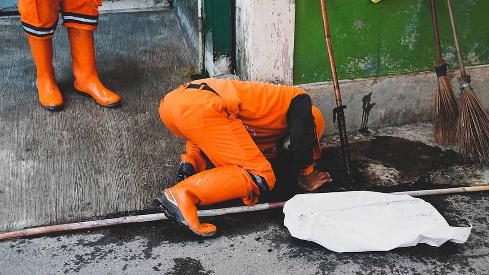 Option One technician inspecting a damaged sewer line Option One technician inspecting a damaged sewer line