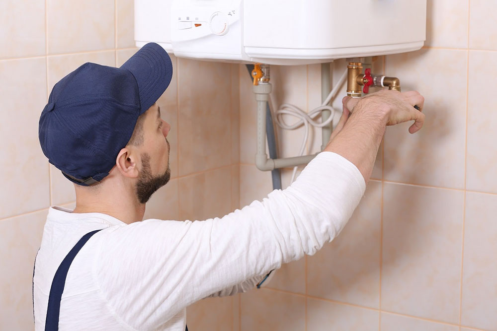 Option One technician installing a new water heater Option One technician installing a new water heater