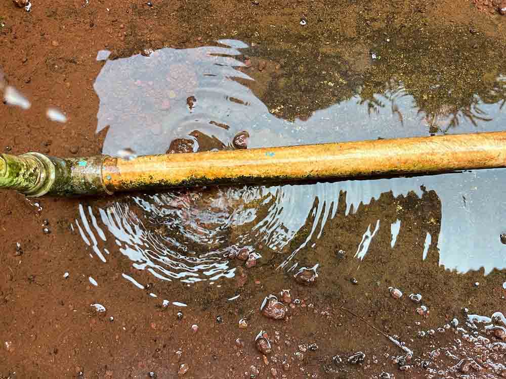 water dripping from a rusty pipe line