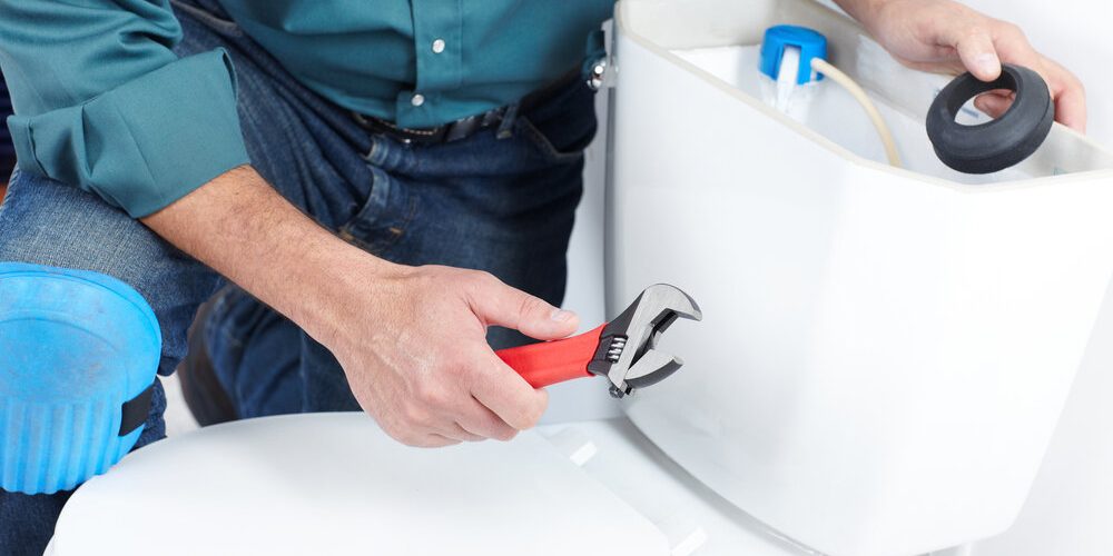 technician-repairing-toilet technician repairing toilet